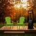 Two green Adirondack chairs on a wooden deck with a heater in the evening.