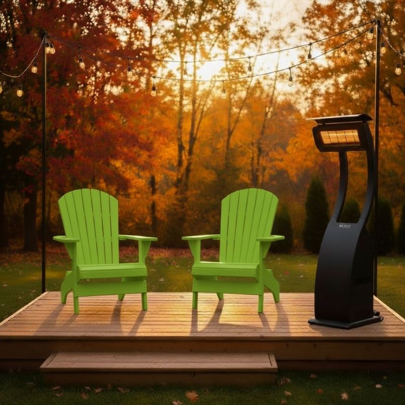 Two green Adirondack chairs on a wooden deck with a heater in the evening.