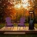 Two purple Adirondack chairs on a wooden deck with a patio heater, surrounded by autumn trees.