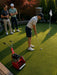 Friends putting on backyard golf green with Rolux S-Series reel mower