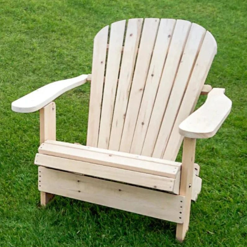Wooden Adirondack chair on a grassy background
