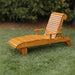 Lounge Chair on grass with trees in the background - clear cedar - golden glossy