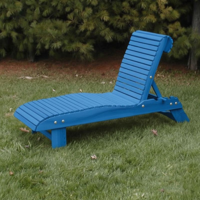Lounge Chair on grass with trees in the background - poly luxe - blue