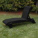 Lounge Chair on grass with trees in the background - poly luxe- black