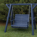 Lovers Porch Swing with Frame Patriot Blue Variant in outdoor set up, with grass and trees.
