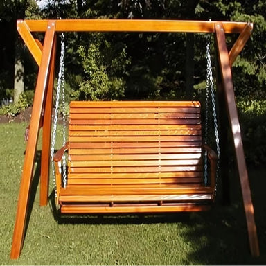 Wooden swing set with a bench seat in a garden setting