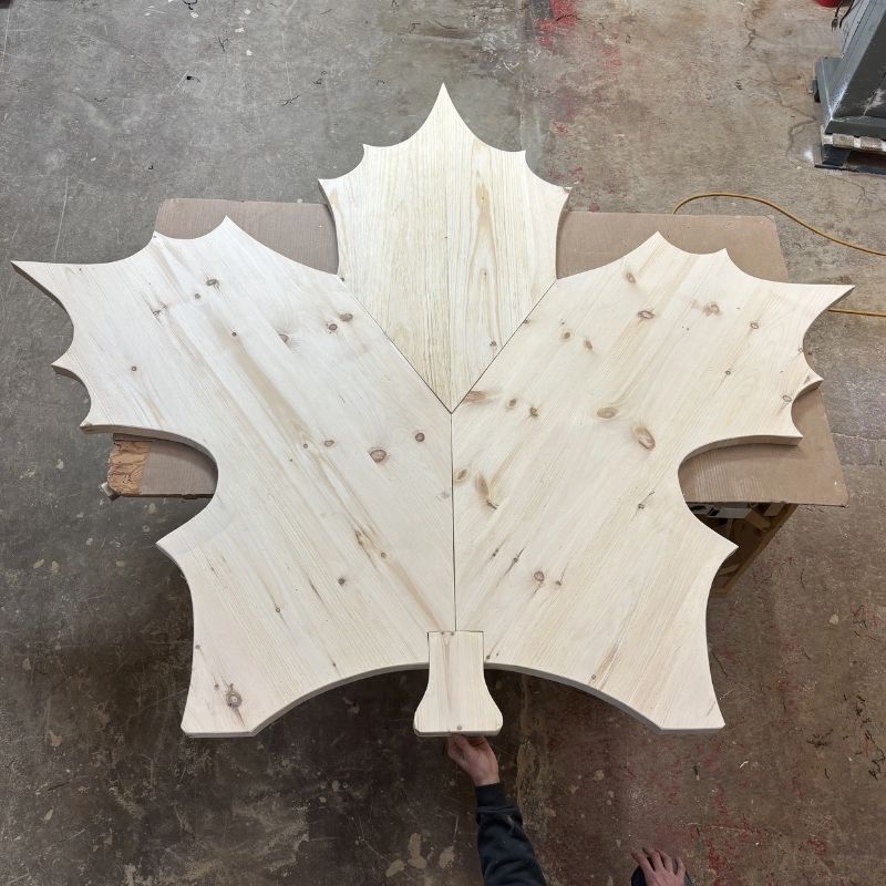 Wooden leaf-shaped object on a concrete floor