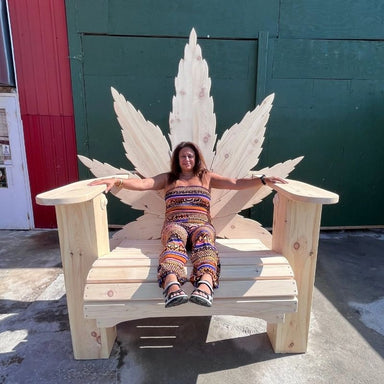 Person sitting on a Marijuandack Giant against a green wall.