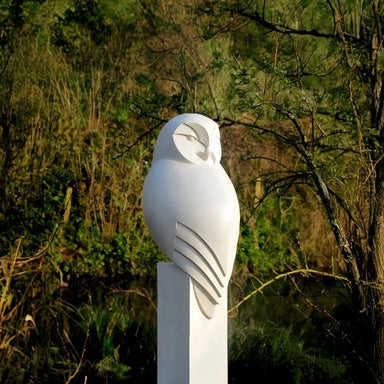Minimalist Perched Owl Marble Outdoor Sculpture outdoor setting with trees