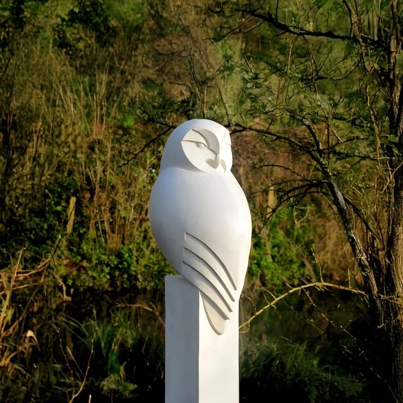 Minimalist Perched Owl Marble Outdoor Sculpture outdoor setting with trees