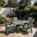 Modern Dining Set for 4 with 6' Tablewith table and chairs on a stone patio, surrounded by plants and trees.