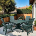 Turf green  Modern Dining Set fir 4 with Pedestal Table in a backyard setting.