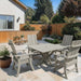 Modern Dining Set for 4 with Pedestal Tableon a sunny day - poly lue - woodgrain driftwood grey
