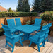 Modern Dining Set for 6 with Pedestal Table on a deck surrounded by greenery - poly luxe - aruba blue