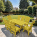 Modern Dining Set for 8 with 6' Table on a patio with a garden and house in the background - yellow