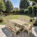 Modern Dining Set for 8 with 6' Table on a patio with a garden and house in the background