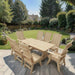 Modern Dining Set for 8 with 6' Table on a patio with a garden and house in the background - birchwood