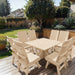 Modern Dining Set for 8 with Pedestal Table on a deck with a garden and house in the background - clear cedar - unstained