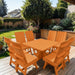 Modern Dining Set for 8 with Pedestal Table on a deck with a garden and house in the background - poly luxe - orange