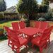 Modern Dining Set for 8 with Pedestal Table on a deck with a garden and house in the background - poly luxe - red