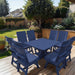 Modern Dining Set for 8 with Pedestal Table on a deck with a garden and house in the background - poly luxe - patriot blue