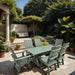 Modern Dining Set for 6 with 5' Table surrounded by plants and a white wall.