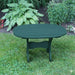 Oval Side Table in a grassy area with plants in the background - poly luxe - turf green