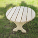Round Side Table with slatted design on a grassy background - poly luxe - woodgrain birchwood