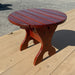 Round Side Table on a wooden deck with a concrete background - knotted cedar - mahogany glossy