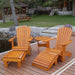 Royal Complete Patio Set on a wooden deck with a garden and building in the background.