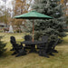 Black Royal Picnic Set for 6 under a green umbrella in a garden setting.
