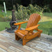 Royal Reclining Glider on a wooden deck with a garden and fire pit in the background - golden glossy