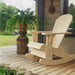 Royal Rocking Adirondack Chair (Large) on a porch with a potted plant and garden view - poly luxe - Birchwood
