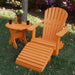 Orange Royal Single Patio Set on a grassy area with flowers in the background
