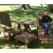 Person sitting on a wooden Adirondack chair in a grassy outdoor setting