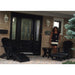 Woman standing in front of a house with black variant of Royal Complete Patio Set