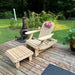 Royal Reclining Glider with ottoman on a wooden deck with a garden background
