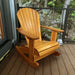 Royal Rocking Adirondack Chair (Large) on a wooden deck with a view of rocks and trees.