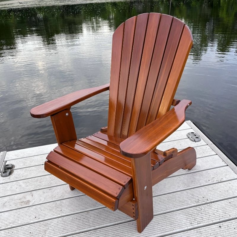 Royal Upright Adirondack Chair,on a dock by a body of water