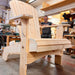 Man in a workshop with Traditional Giant chair he has been working on.