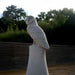 Watchful Owl Marble Outdoor Sculpture outdoor setting with trees on the background